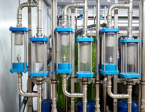 The system features stainless steel piping and industrial-grade water treatment tanks.