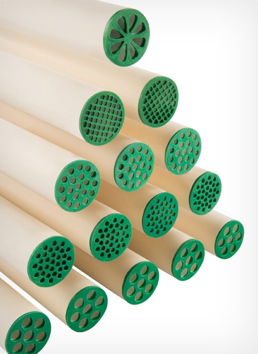 Industrial ceramic membrane tubes with green multi-channel filtration openings.