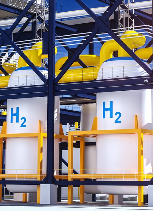 Two large white tanks that have H2 (dihydrogen) on them with yellow pipes coming out of the top.
