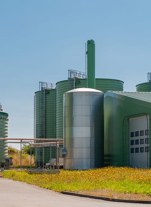 Green building in background with steel silo in front