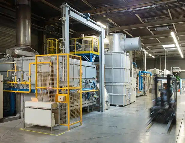 À l'intérieur d'un site de production, avec un chariot élévateur flou sur la droite